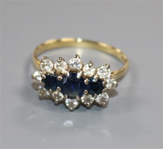 An 18ct gold, sapphire and diamond fifteen-stone cluster ring, claw set, size Q.
